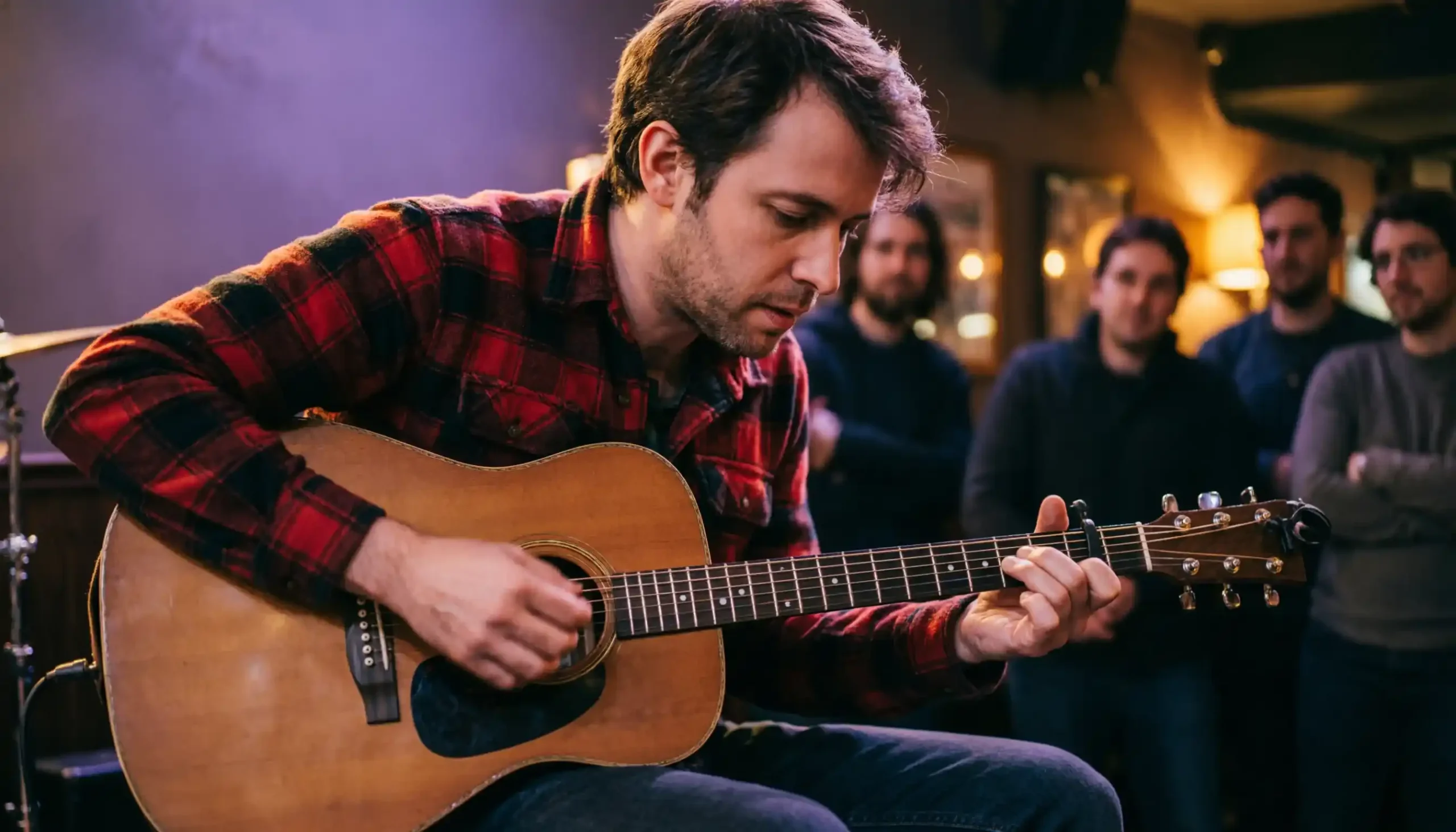 Jet Elfman indie musician performing folk music with acoustic guitar on stage